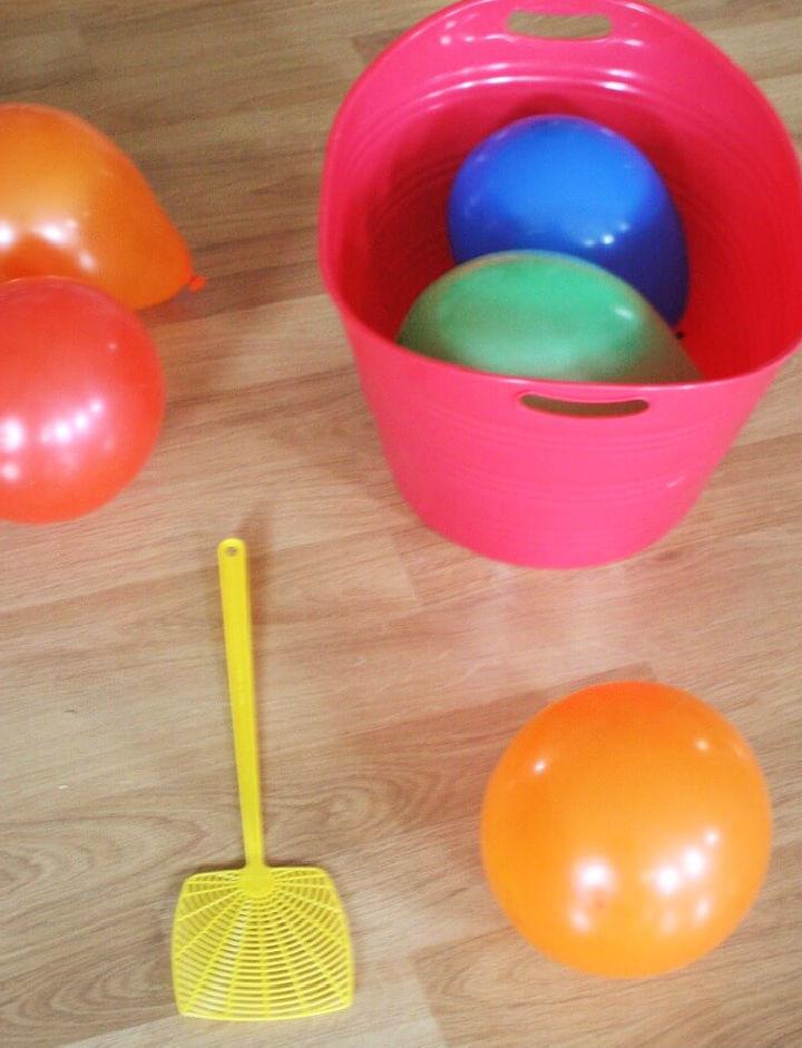 Make a Balloon Tennis for Gross Motor Play