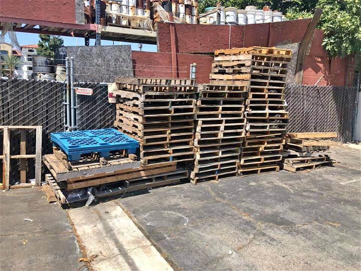Find free pallets outside of businesses. but ask first