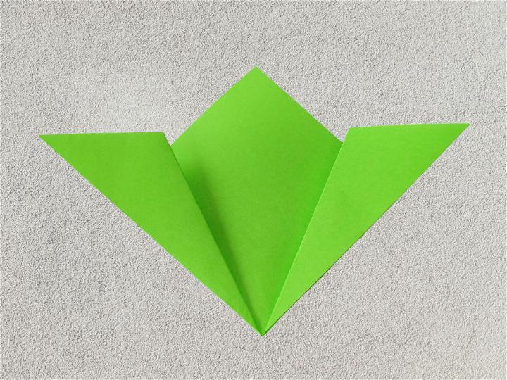 Fold the same points down. The folded edge will line up exactly on top of the outside edge of the square.