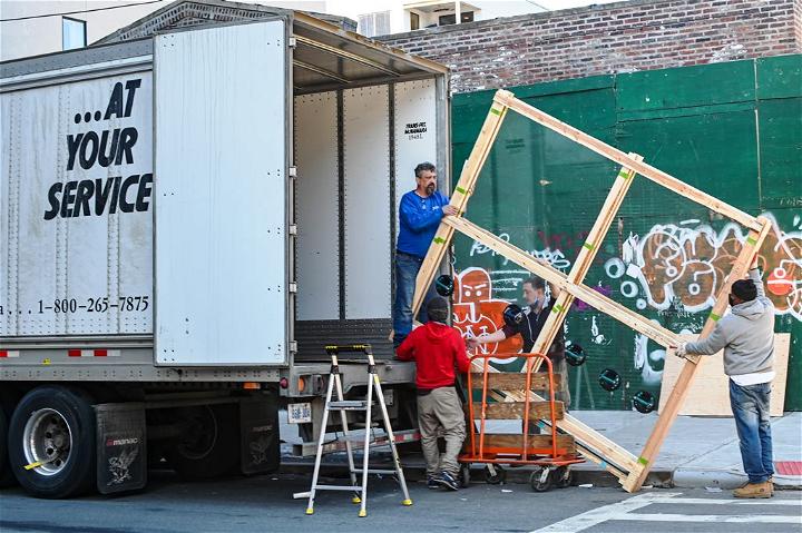 A team of movers loading in a truck during home renovation