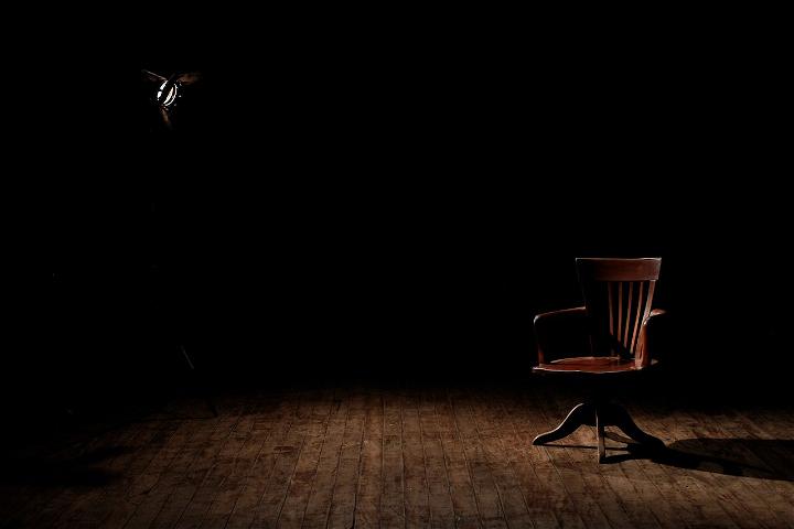 Chair in a dark room.