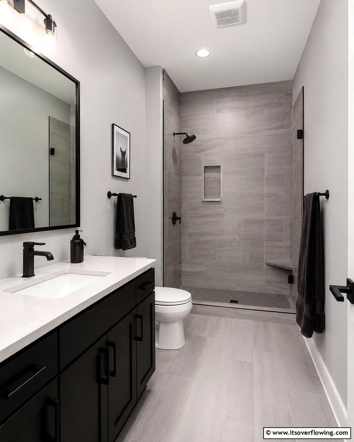 Black Fixtures Against Grey Walls - 25 Black and Grey Bathroom Ideas for a Sleek Design