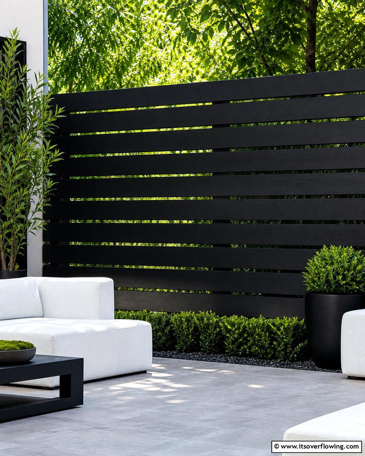 Black Slatted Fence for Sleek Sophistication - 25 Small Garden Fence Ideas for Your Outdoor Space