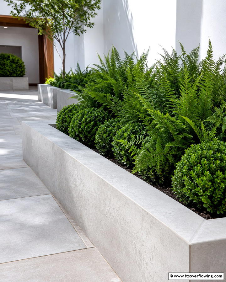 Raised Concrete Borders for Structural Stability - 25 Low Maintenance Garden Border Ideas for Easy Landscaping