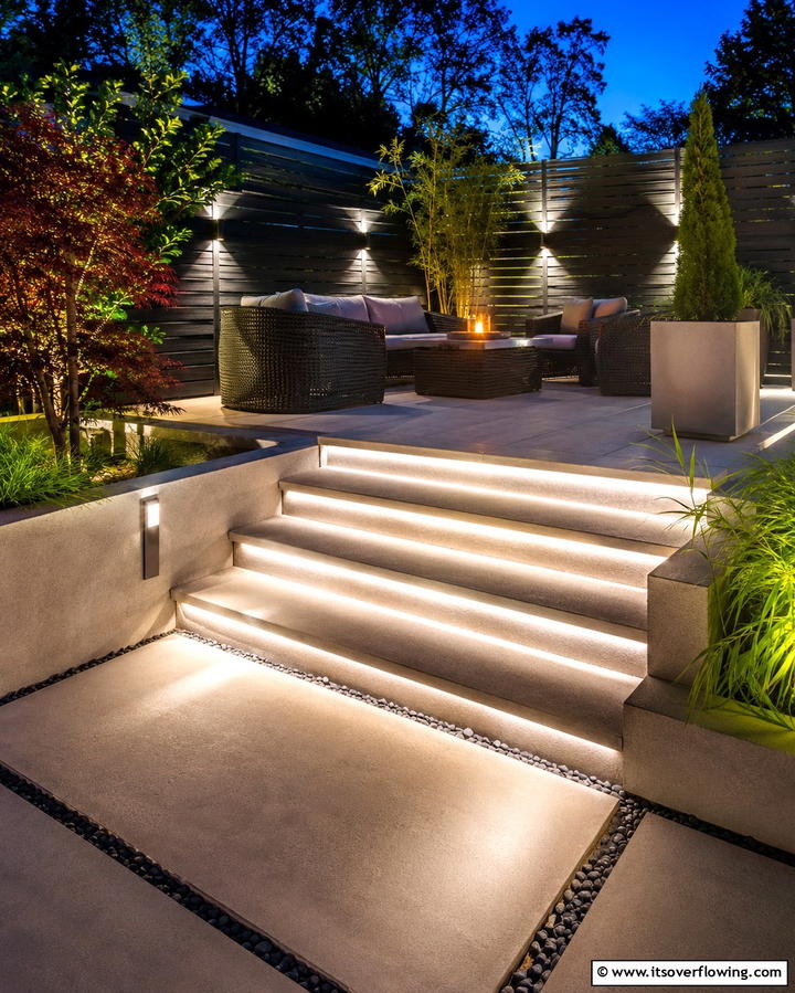 Raised Patio with Accent Lighting Under Steps - 25 Raised Concrete Patio Ideas for a Modern Outdoor Space