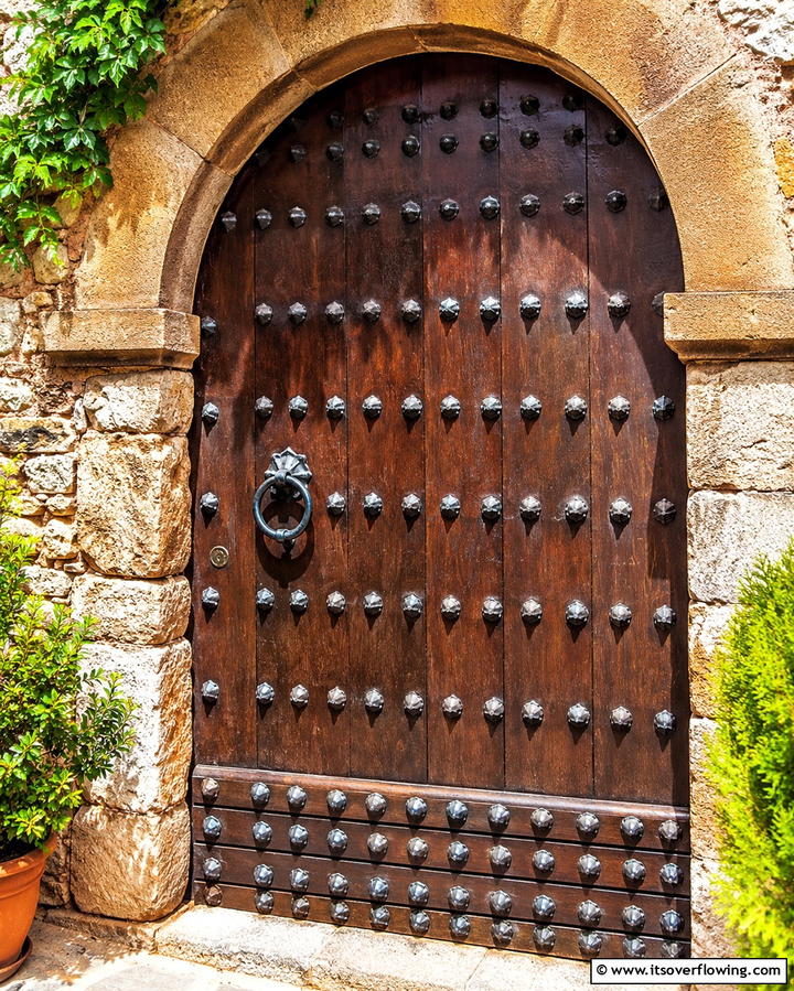 Studded Metal Details - 25 Spanish Style Front Door Ideas for Curb Appeal