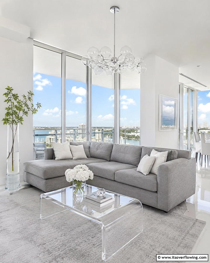 Use Glass and Transparency - 30 Grey Couch Living Room Styling Ideas for Cozy Spaces