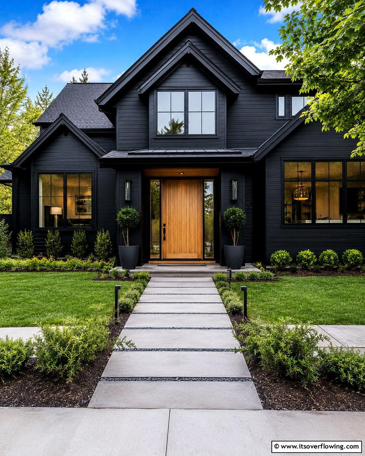 Wooden Front Door Against a Black Facade - 25 Black House With Wood Accents Ideas for a Bold Design