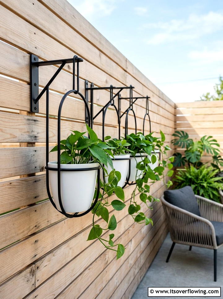Black Metal Plant Hangers - 25 small garden ideas with hanging baskets
