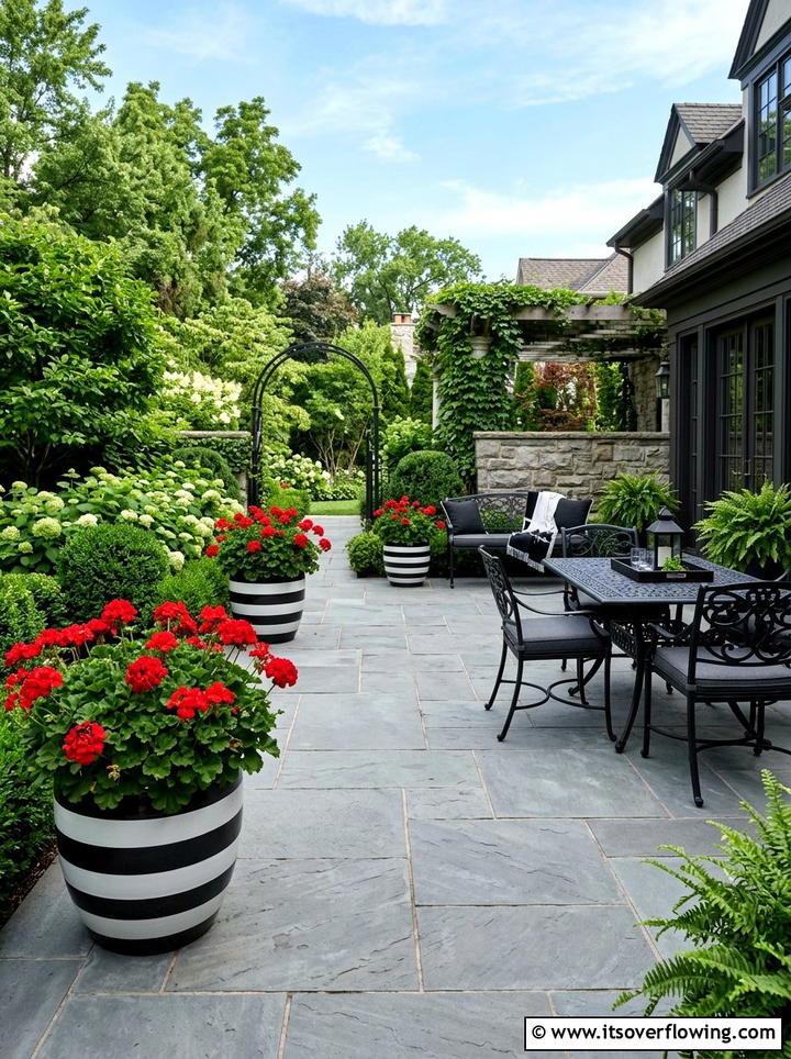 Bold monochrome patio with striped planters - 25 creative garden ideas with painted planters