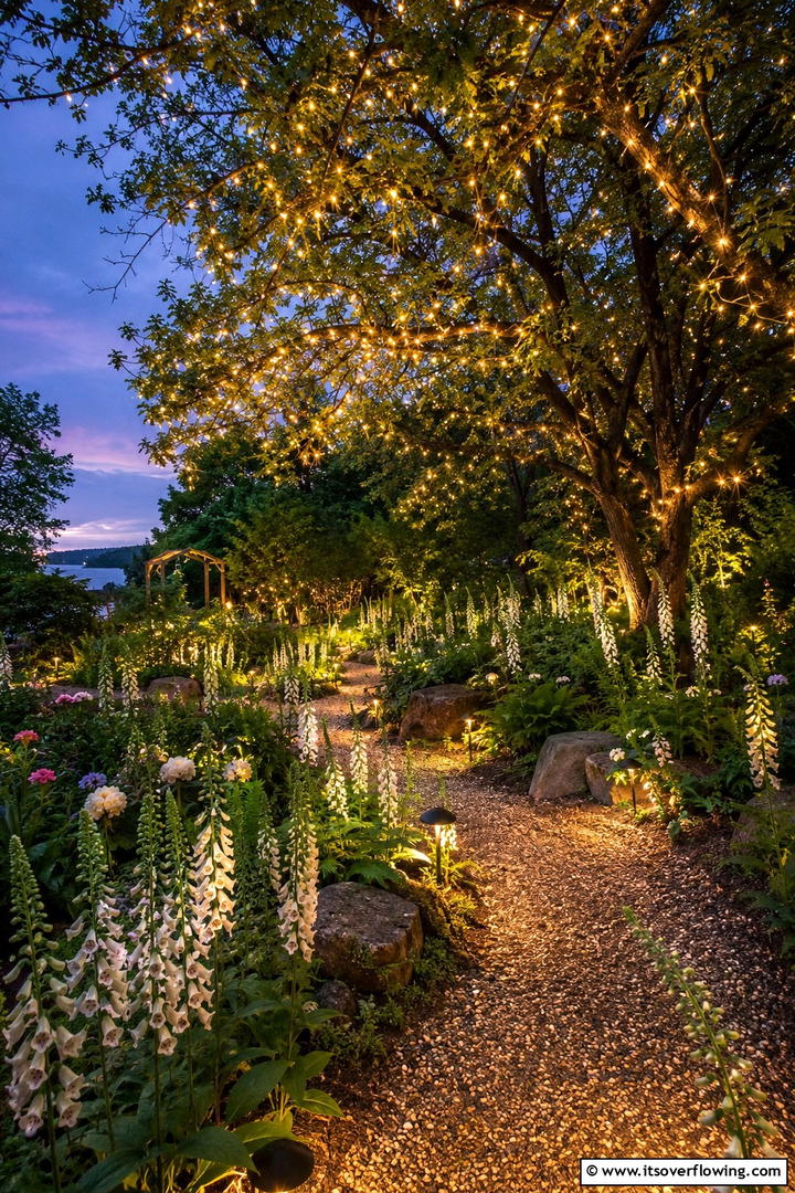 Enchanted Garden with Fairy Lights - 30 Sloped Garden Ideas to Transform Challenging Yards