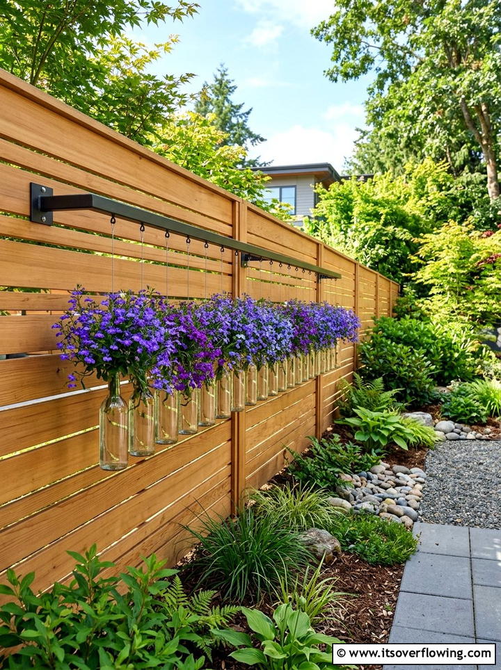 Horizontal hanging bottle row - 25 creative garden ideas with hanging bottle planters