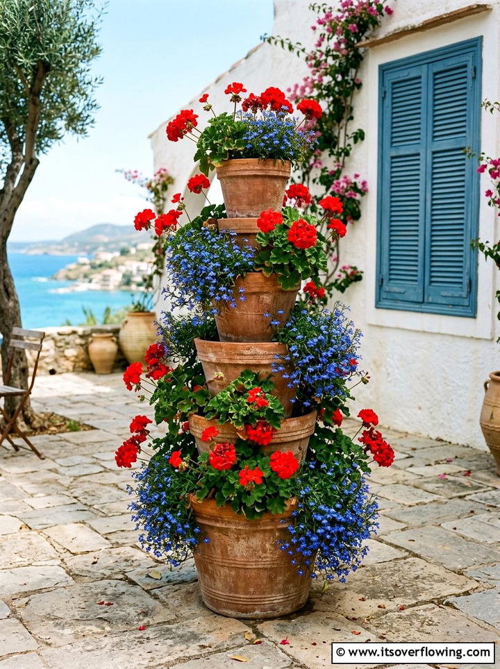 Tiered terracotta pot tower - 25 garden decor ideas with floral displays