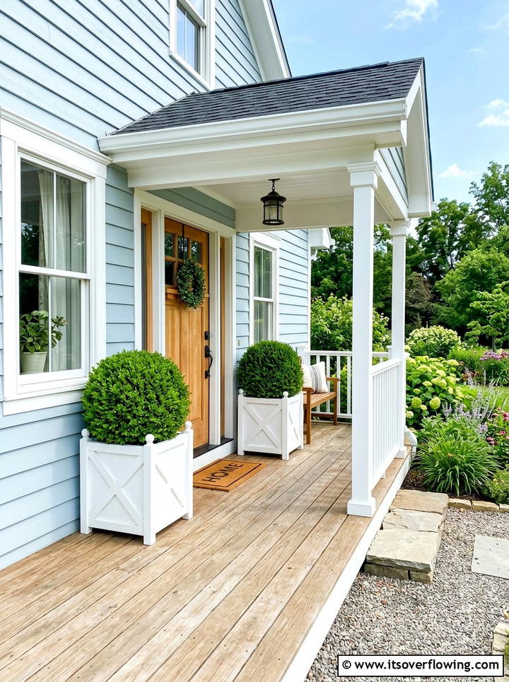 White planter boxwood topiary display - 25 front porch decor ideas with topiaries